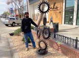 Local businessman Dereck Marsh stands proudly next to the unique sculpture that he created for his downtown planter, part of a city-wide program to improve Lemoore's downtown.